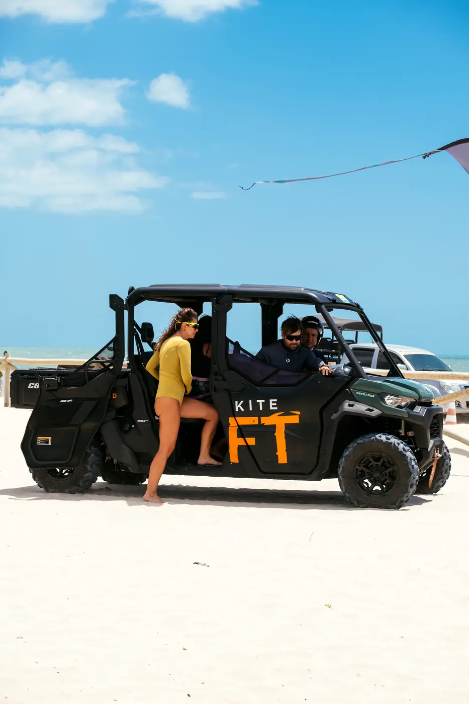 Buggy do serviço Kite Lift estacionado na areia, com kitesurfistas embarcando