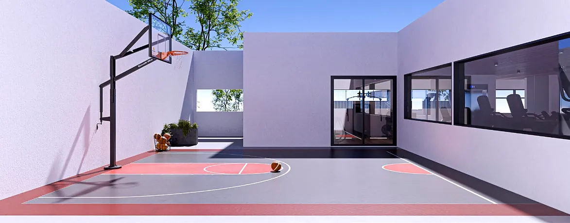 Open-air basketball court between light-coloured walls