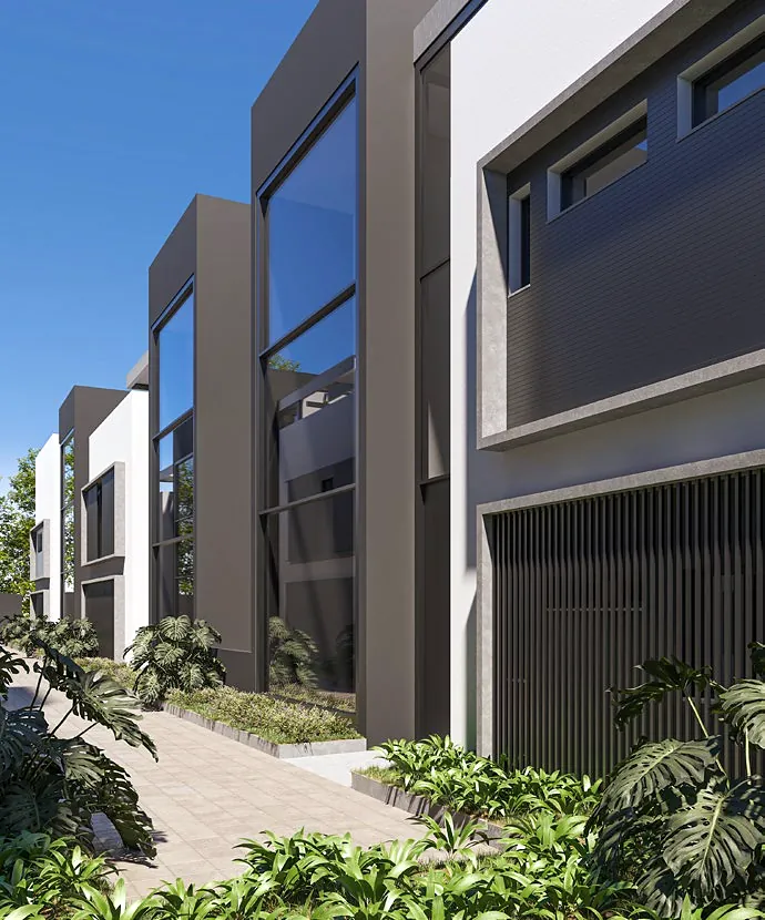 Landscaped walkway between the house façades, with tall glass frames