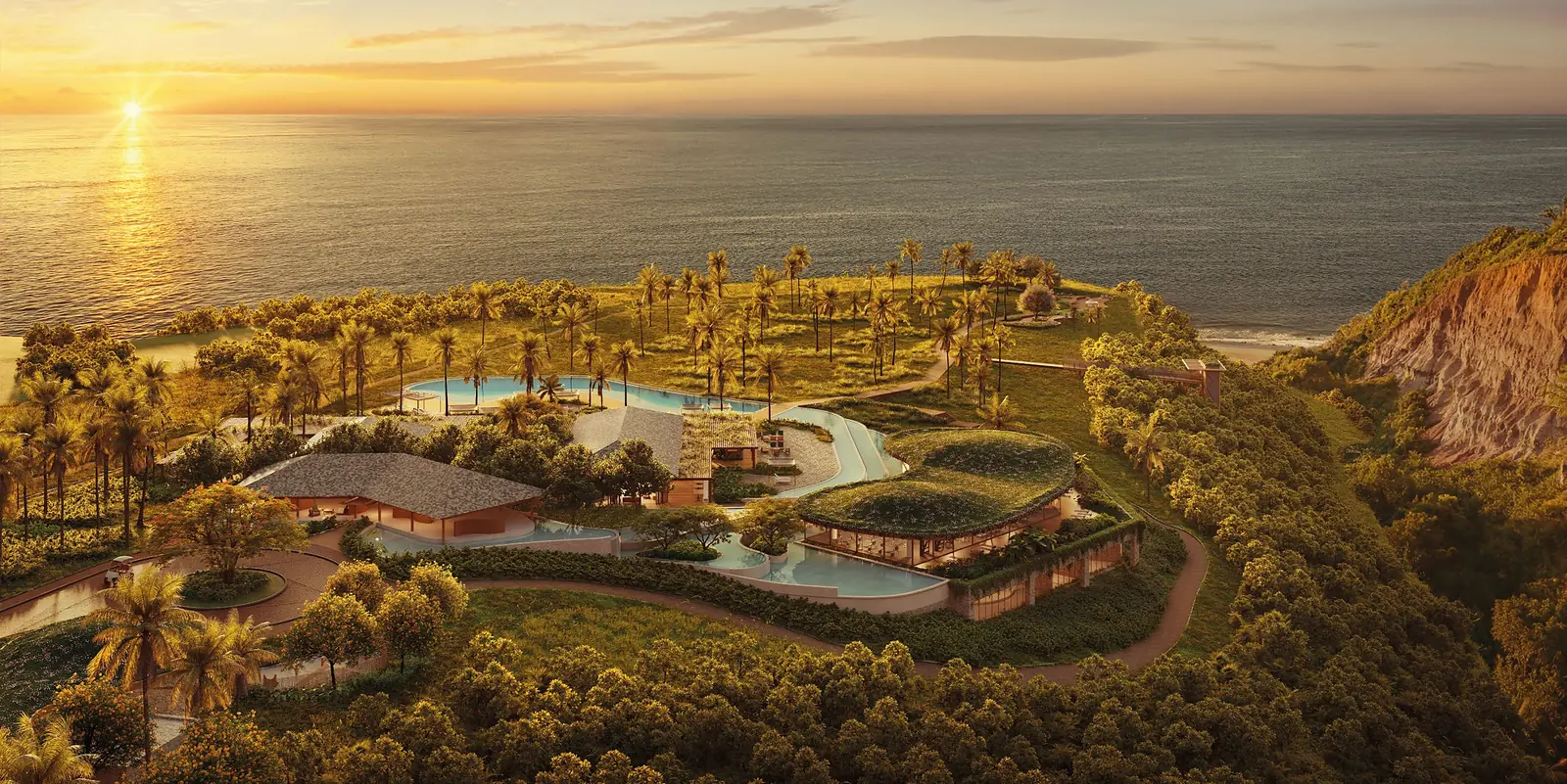 Vista aérea do Clubhouse Falésia ao pôr do sol, com piscinas sinuosas, coqueiros e o mar ao fundo