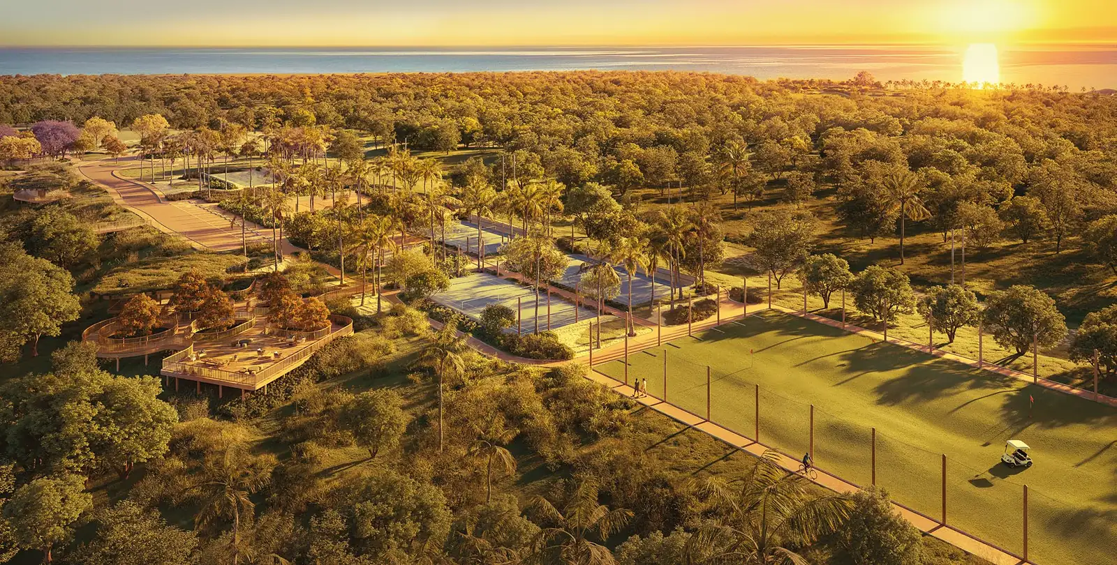 Vista aérea do Esporte Park ao entardecer, com golf range, quadras e decks entre as árvores